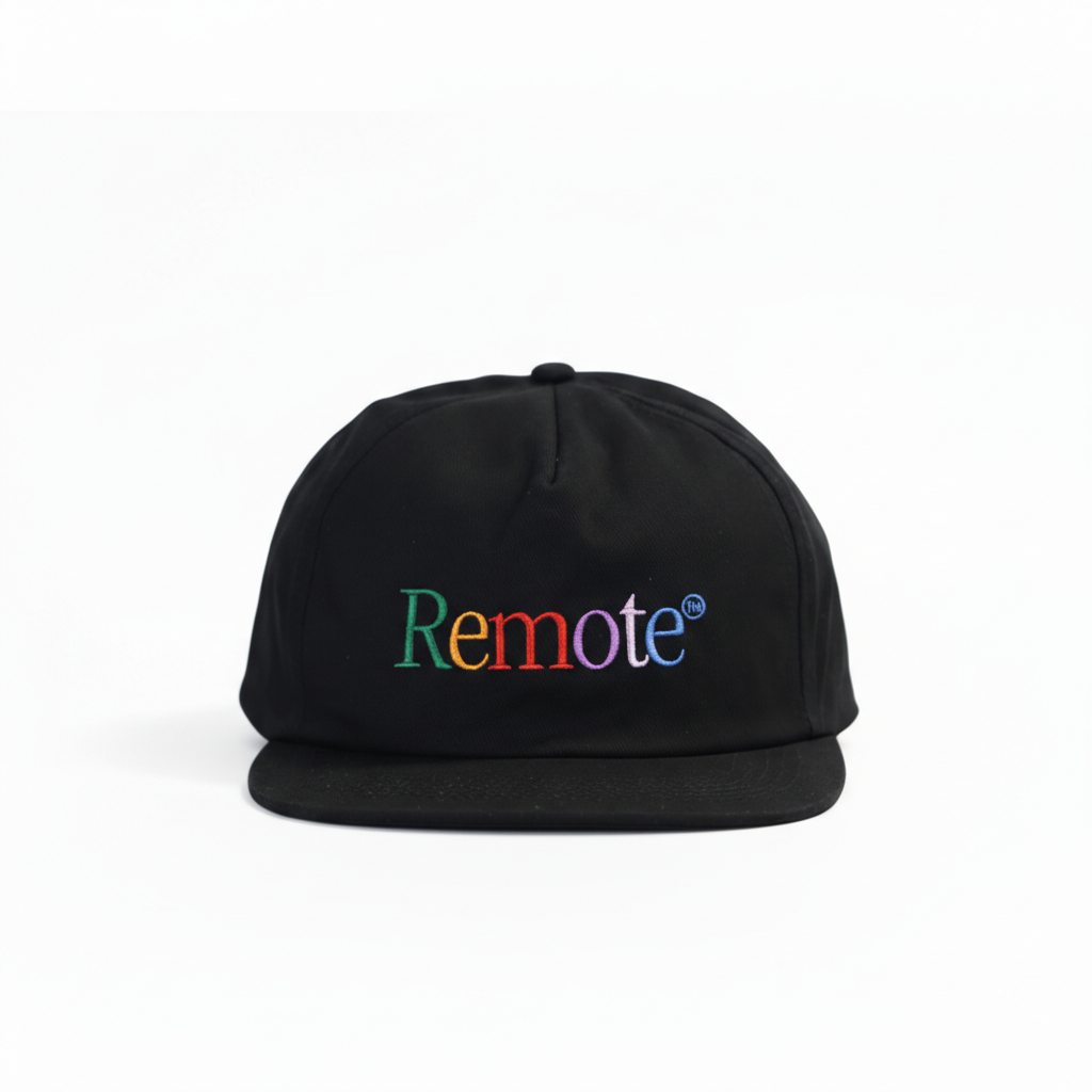 Black embroidered nylon “Remote” 5-panel hat with multicolor lettering on a white background